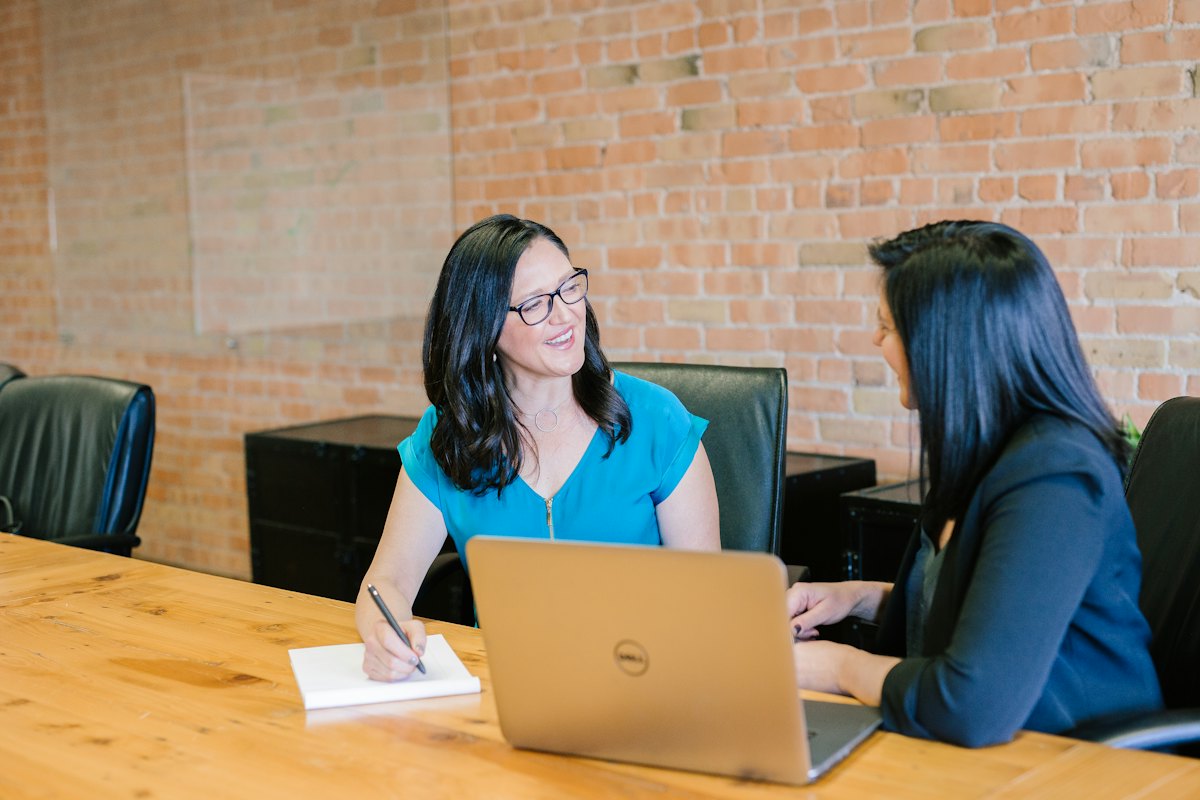 A tax preparer reviewing a return with a client at a laptop